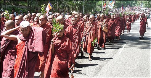 Buddhist monks protest the military junta in Rangoon, cheered on by supporters. About 700 staged a similar show of defiance in the second-largest city, Mandalay. (Associated Press)